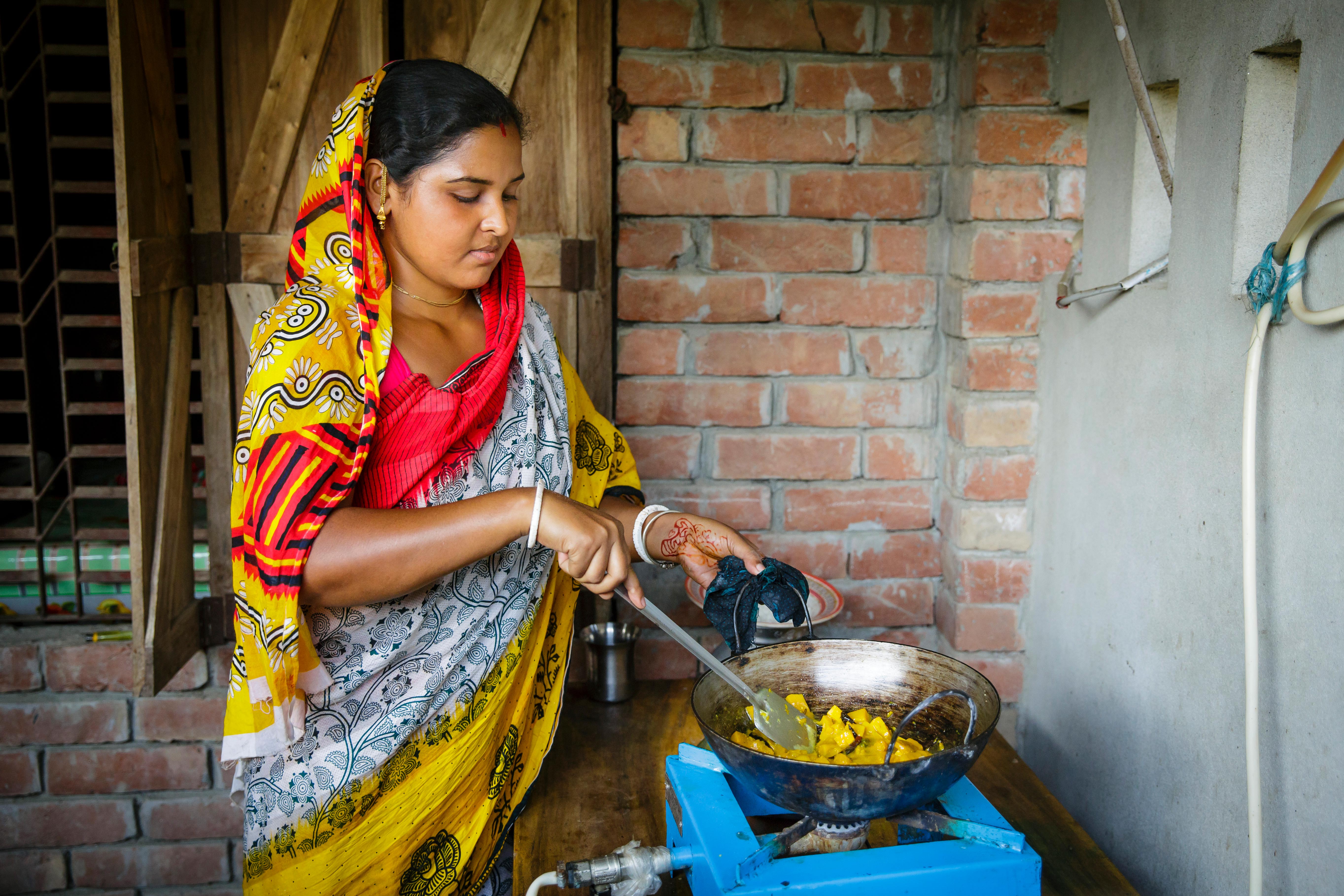 Clean Cooking_GettyImages Women cooking on a gas stove