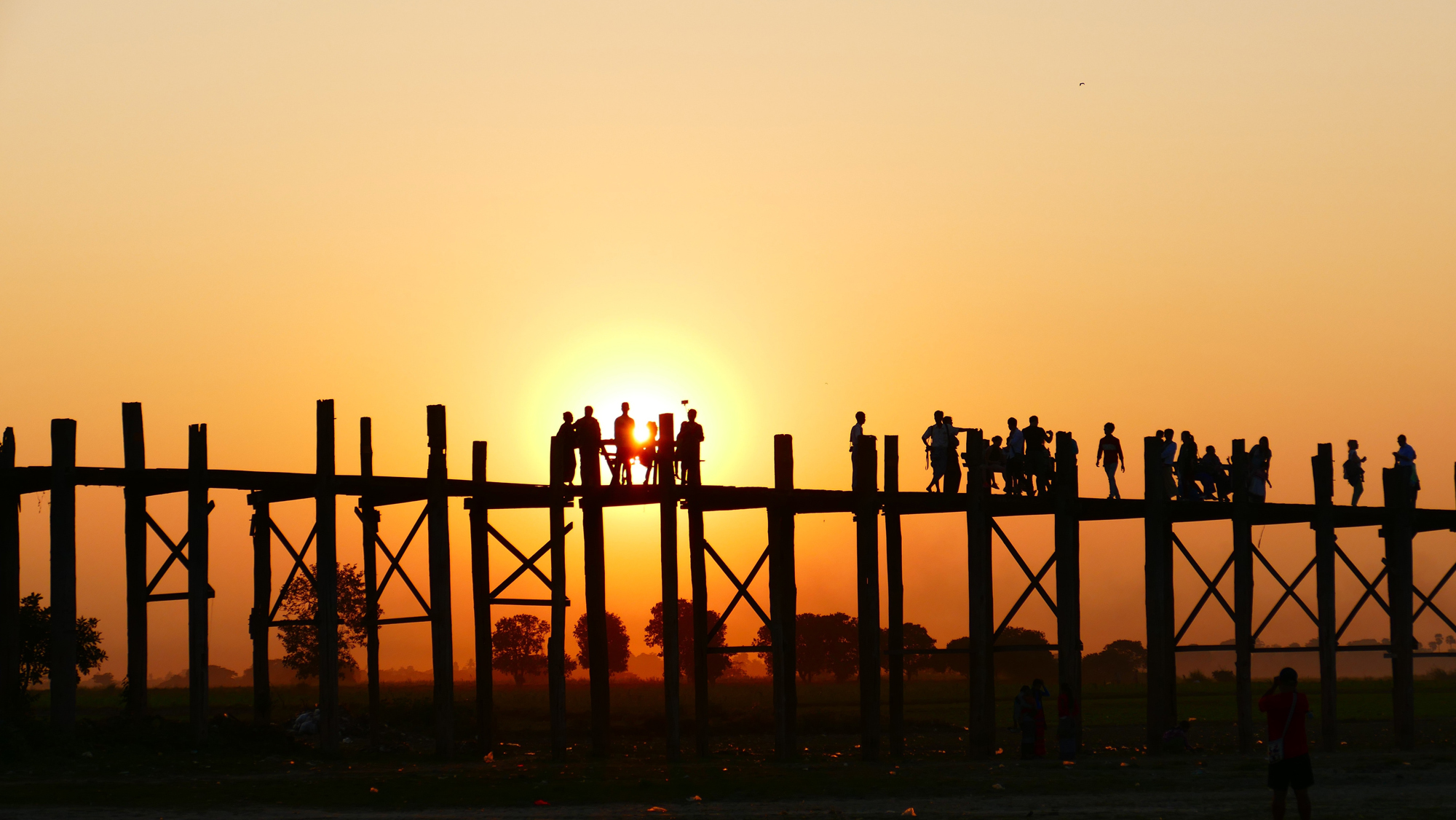 sunset-wide Group of people on a bridge at sunset