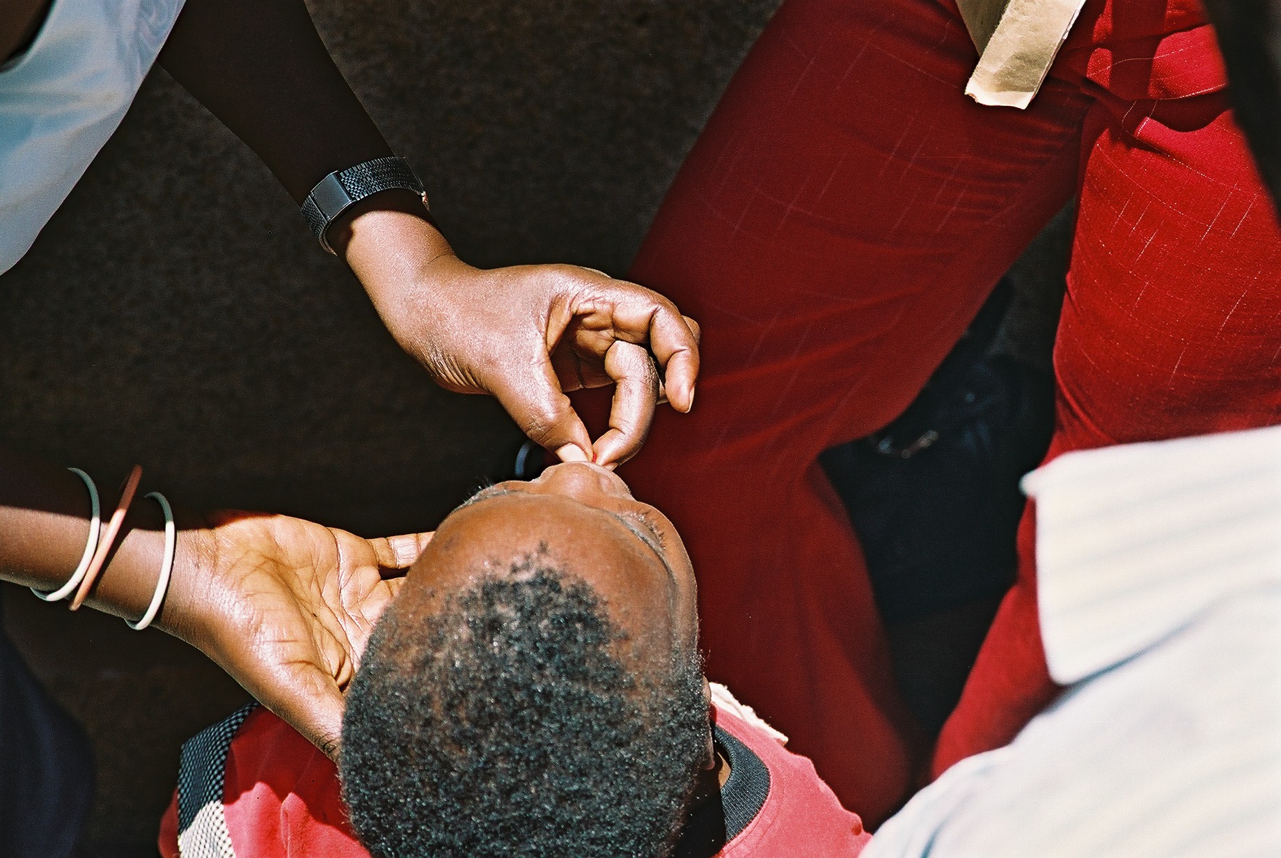 WHO_Henrietta_Allen_WHO_004111 Young child receiving medicine from mother