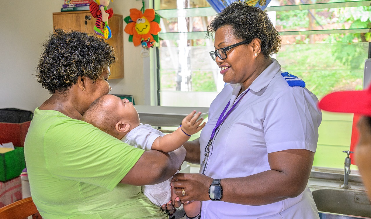 A mother and her baby during a consultation with a nurse at Yalobi Nursing Station, Waya Island A mother and her baby during a consultation with nurse Adi Elcasi Dawale at Yalobi Nursing Station, Waya Island.