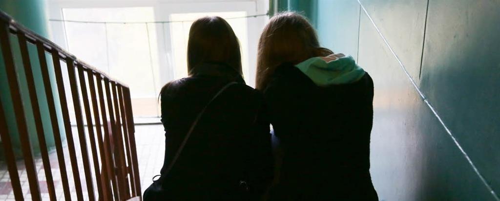 Mental health - staircase Two women sitting on a staircase