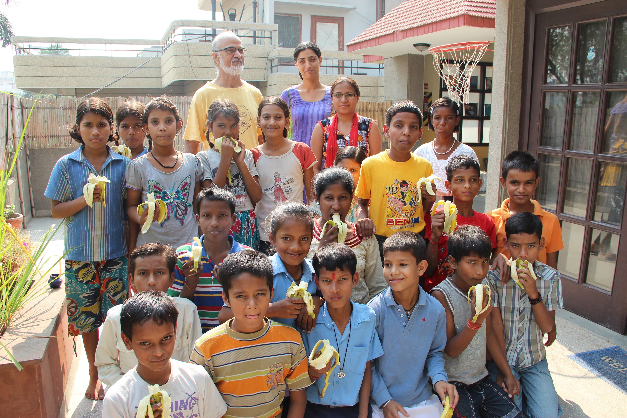 children-eating-fruits Group of children eating bananas