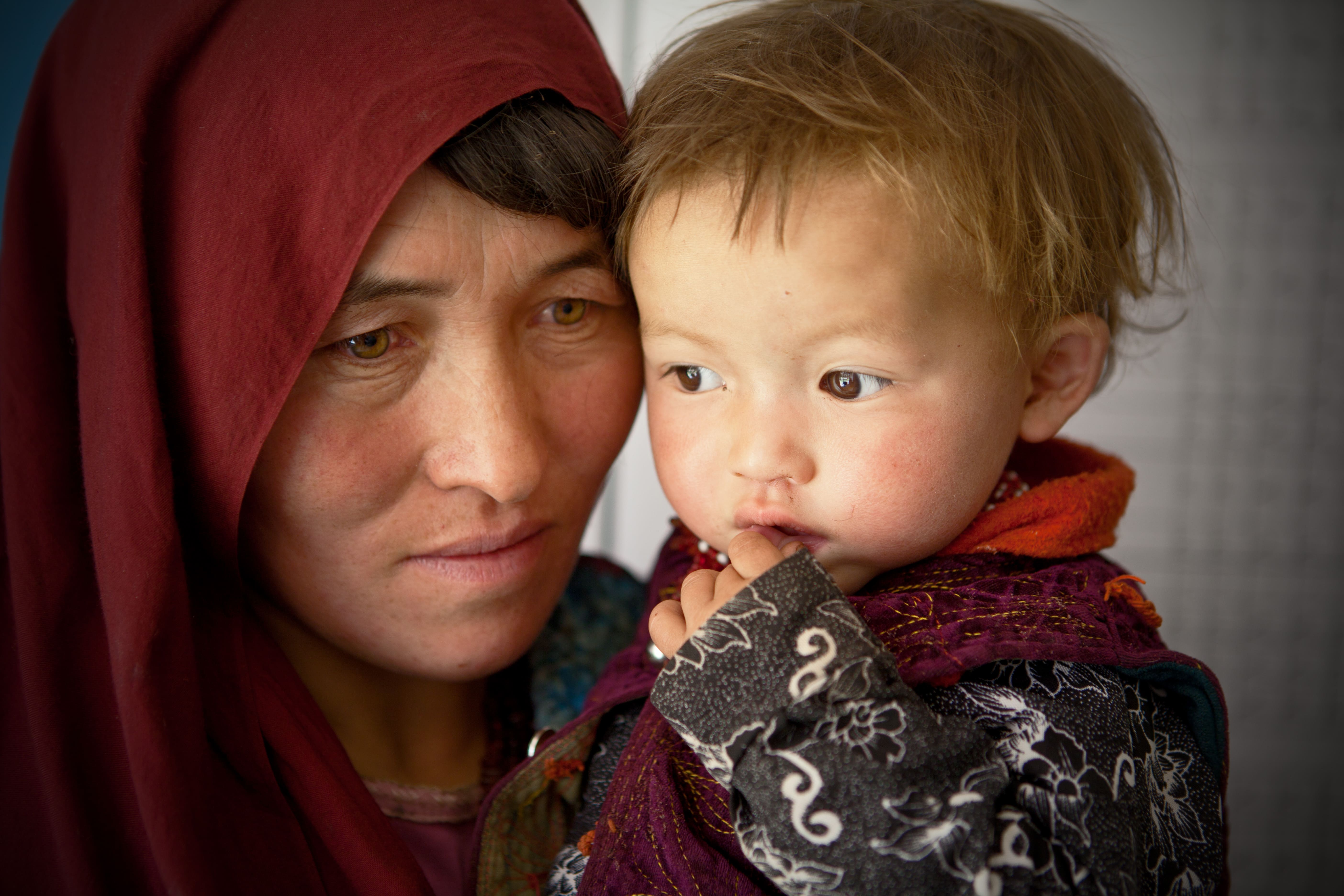 Woman daughter Afghanistan An Afghan woman holds her one year old daughter Roqia at Family Health House on September 8, 2014 in Shiber district of Bamiyan, Afghanistan.