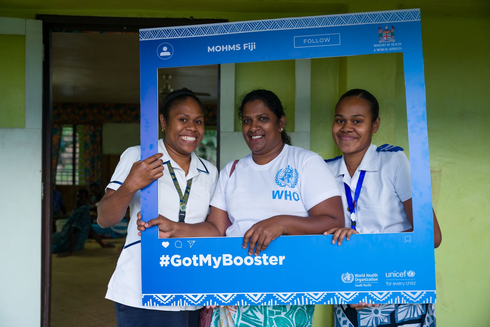 WP48767 Nurses pose with a twitter photo frame promoting COVID-19 vaccination